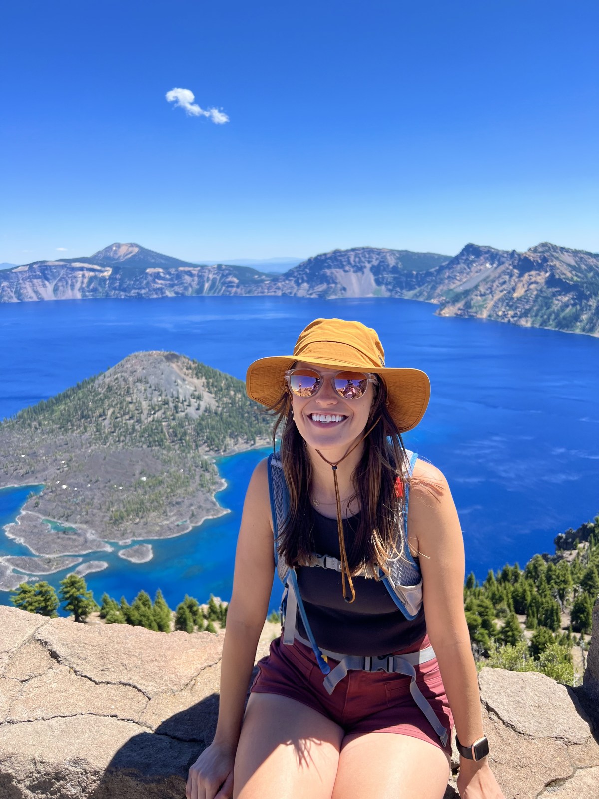 Woman sitting with Crate Lake National Park in the background