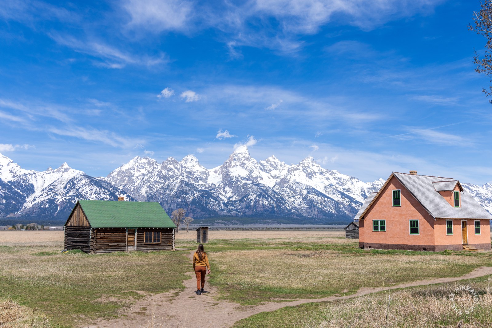 Lauren walking out to Mormon Row with the Teton Mountain Range in the distance at Grand Teton National Park, Wyoming