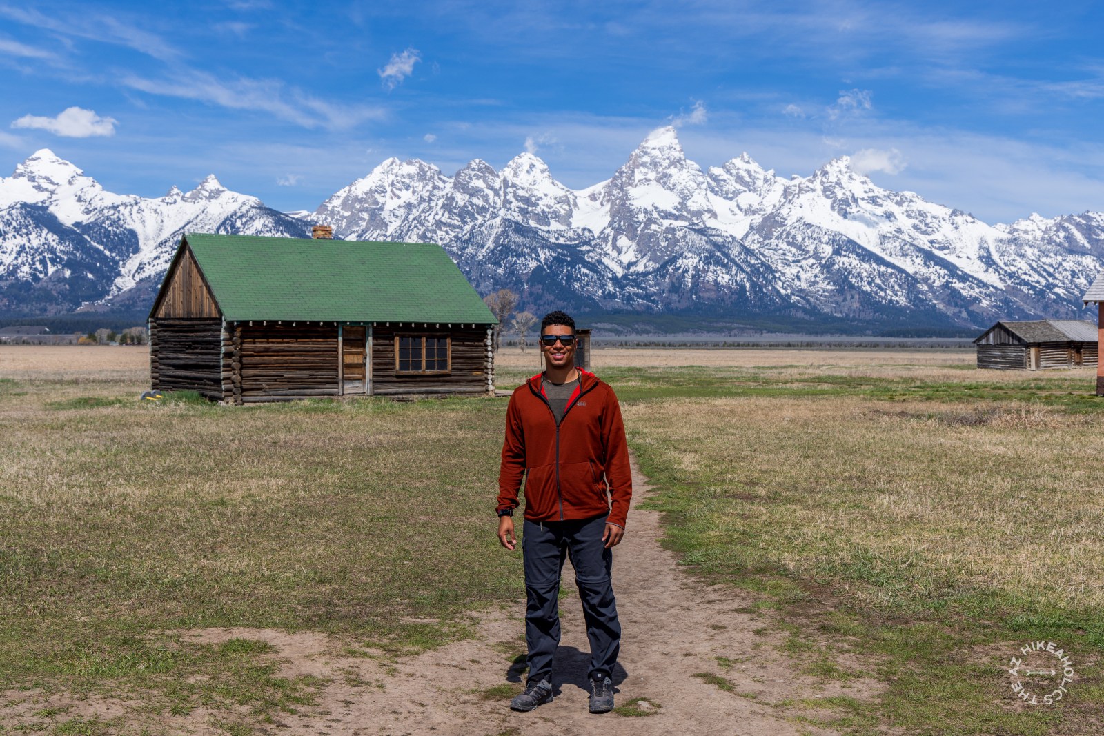 Owen standing in front of Mormon Row with the Teton Mountain Range in the distance at Grand Teton National Park, Wyoming